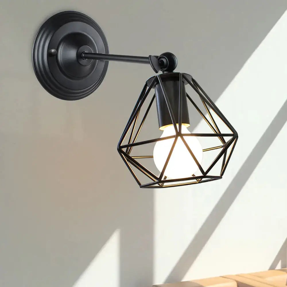 Black metal led pendant light with geometric cage design housing illuminated bulb for vintage loft decor