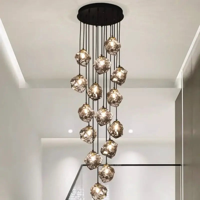 A modern DecorBites LED pendant light with irregular translucent glass orbs hanging from a black ceiling mount ideal for staircase lighting