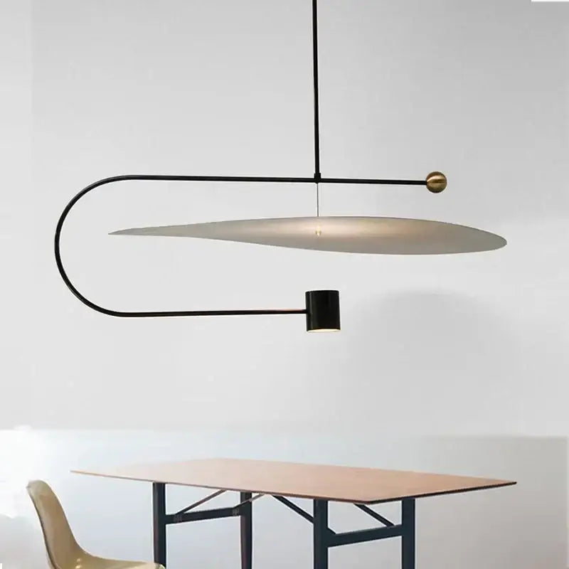 Modern black and brass minimalist DecorBites™ pendant light fixture with curved frame and oval shade for indoor lighting