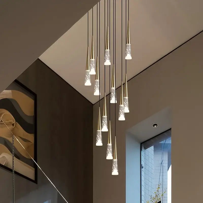 Modern gold-toned pendant light with frosted glass shades in a cascading design for decorbites led rain drop chandelier
