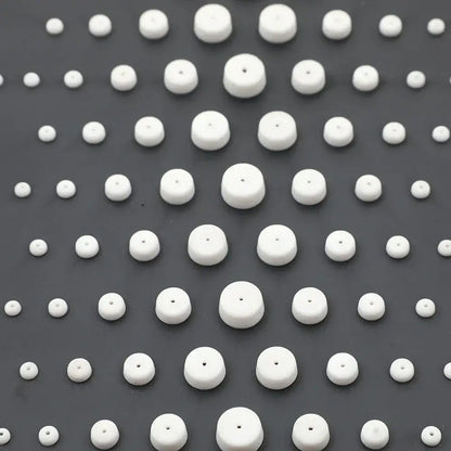 White ceramic beads arranged in a grid pattern complement the decorbites™ led rain shower set with digital display and bidet mixer faucet