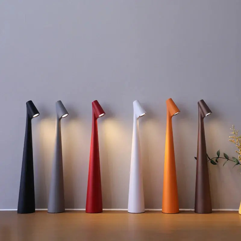 A sleek modern DecorBites™ LED rechargeable desk lamp with tapered conical body and adjustable head for study use
