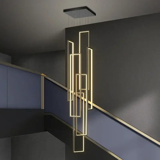 Modern geometric decorbites led rectangle chandelier with glowing gold strips suspended from black ceiling fixture for staircase