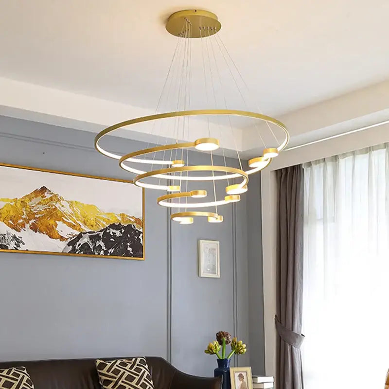 Modern gold-toned led ring chandelier with concentric rings and integrated leds for dining living room and lobby lighting