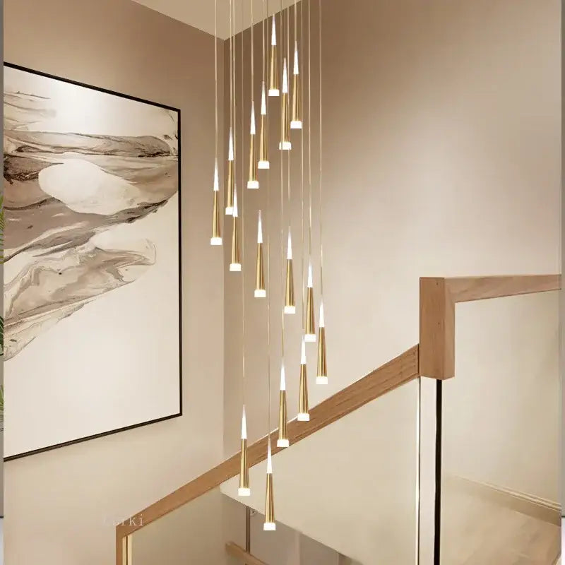 Modern gold-toned led ring chandelier with slender tapered cylindrical shades cascading for villa and kitchen lighting