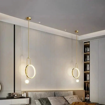 Two elegant gold-toned led ring pendant chandelier lights with circular rings and spherical bulbs for home decor