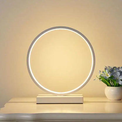 Modern nordic decorbites led ring table lamp with sleek white frame and warm glow on minimalist base