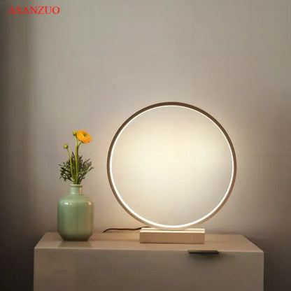 DecorBites™ led ring table lamp with a sleek metallic frame and warm glow on a minimalist wooden base for bedroom lighting