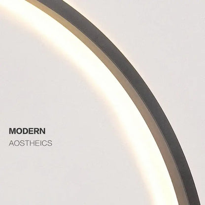 A sleek DecorBites™ LED ring wall lamp with dark metallic frame and soft glowing illumination for indoor use