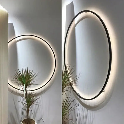Modern oval DecorBites™ led ring wall lamp with sleek black frame and warm glowing led ring for indoor use
