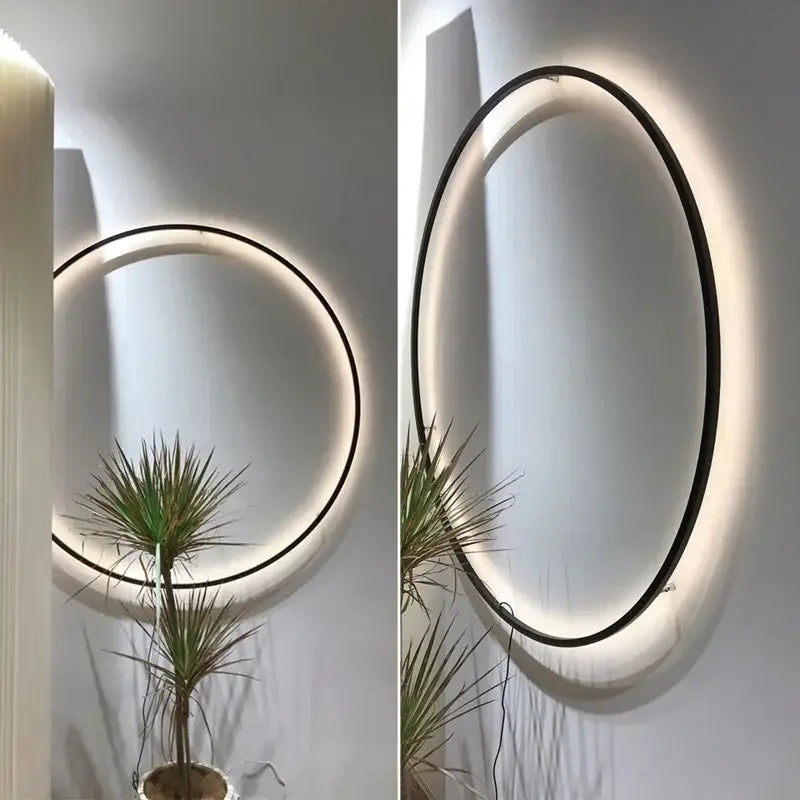 Modern oval DecorBites™ led ring wall lamp with sleek black frame and warm glowing led ring for indoor use