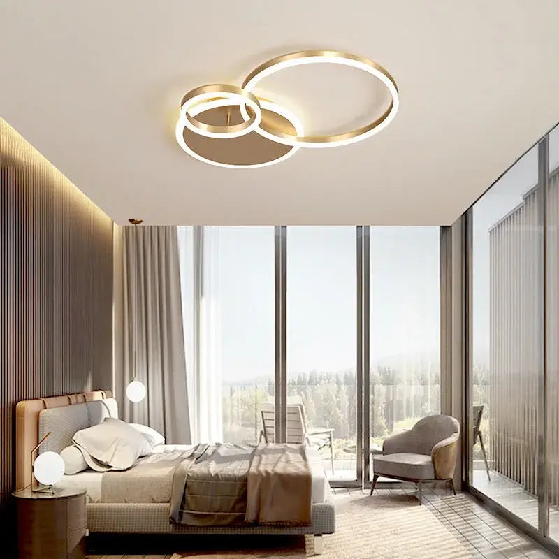 Modern gold-toned decorbites™ led rings ceiling chandelier with overlapping rings and integrated dimmable led lighting for indoor use