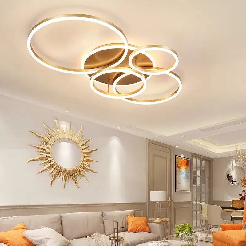Modern gold-toned led rings ceiling chandelier with overlapping circular rings for dimmable indoor living room use