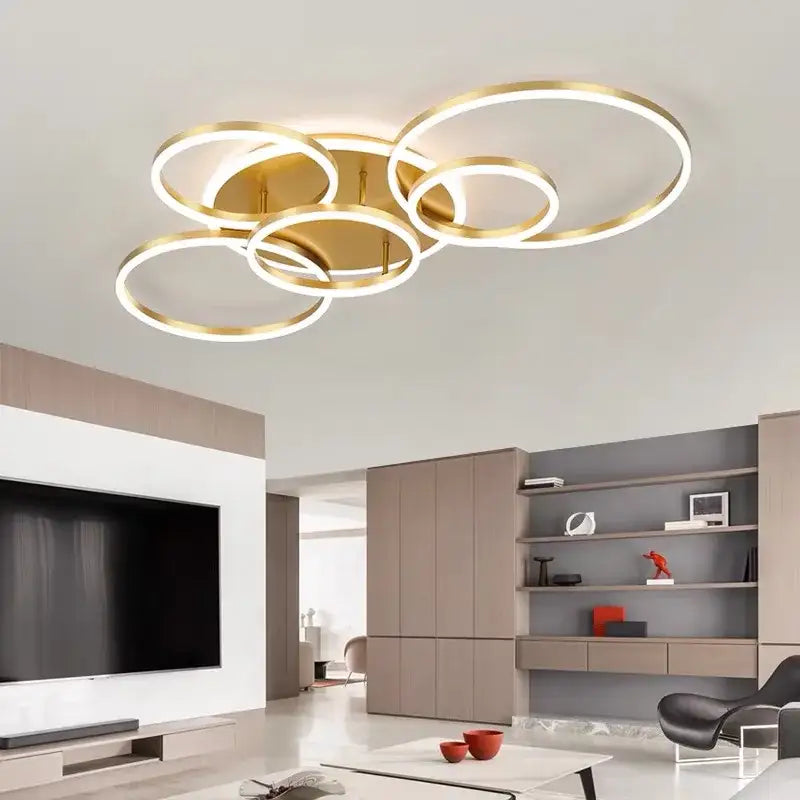 Modern gold-toned led rings ceiling chandelier with overlapping rings and illuminated edges for dimmable indoor use