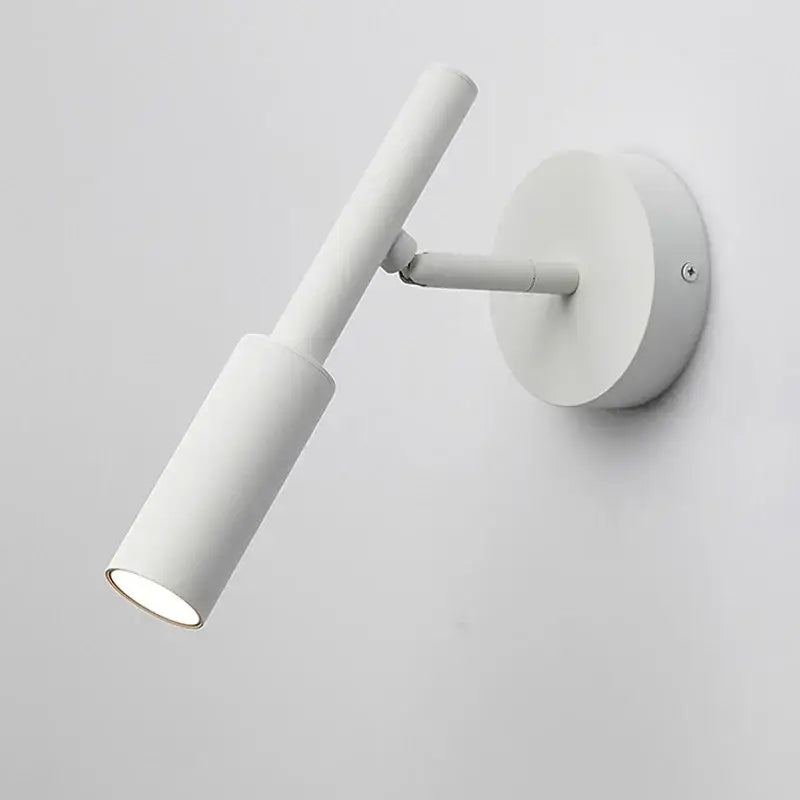 White cylindrical DecorBites™ led rotatable wall lamp with adjustable arm and circular base for bedroom lighting