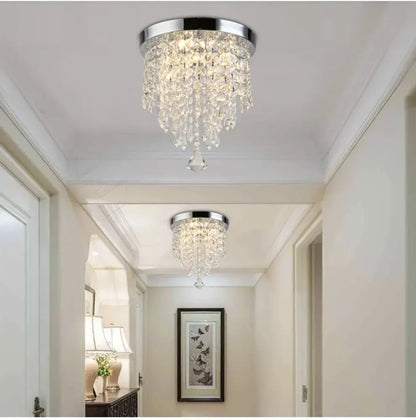 Chrome-finished crystal chandelier with cascading glass prisms and polished metal base for decorbites led round ceiling light