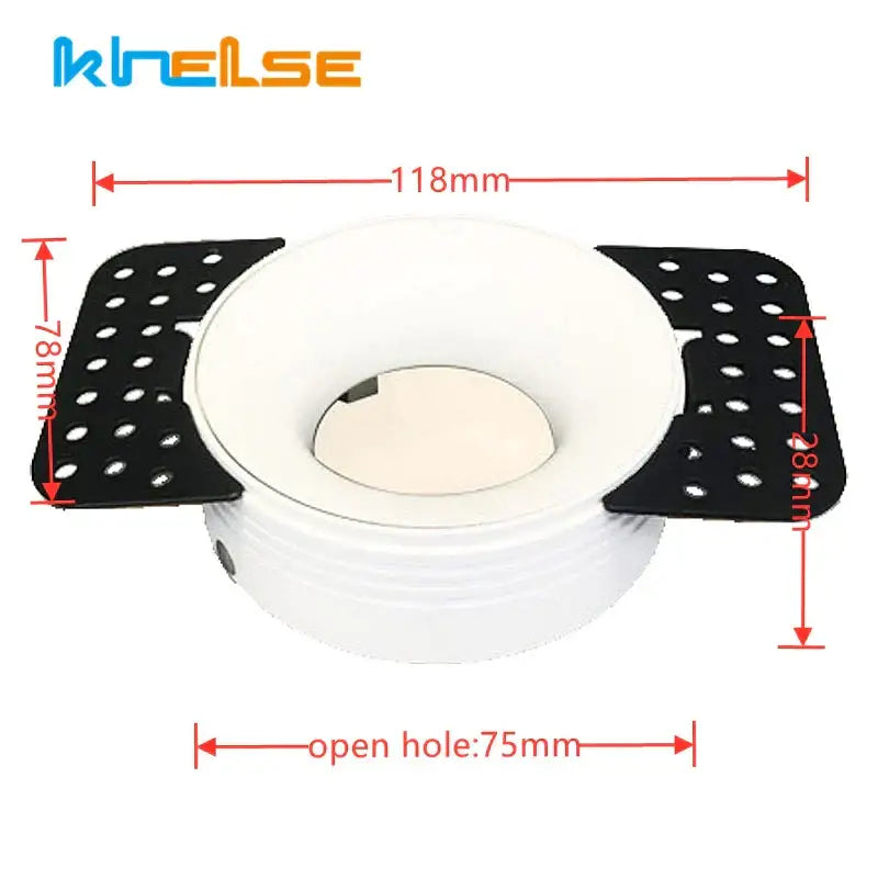 White and black kneelse brand toilet seat riser with perforated side panels shown with decorbites led round recessed fixture