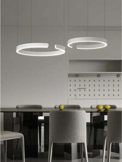 Modern white circular decorbites led round ring chandelier with minimalist design hanging above dining table