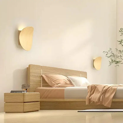 Pair of DecorBites™ LED round wall lamps with minimalist crescent shape and warm-toned wood finish for indoor lighting