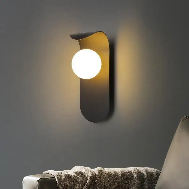 Modern matte black decorbites led round wall lamp with sleek curved design and warm white spherical bulb for indoor lighting