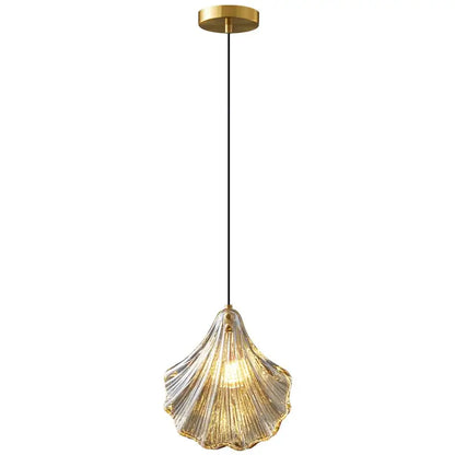 Decorbites led shell pendant light with translucent glass shell and brass mount emitting warm golden glow