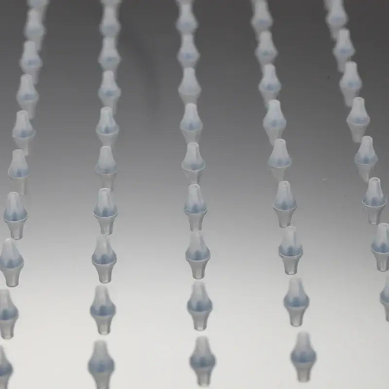 Translucent blue plastic pipette tips arranged in rows alongside decorbites led shower head with temperature control and led lights