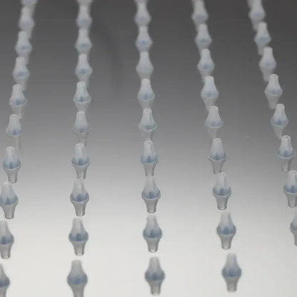 Translucent blue plastic pipette tips arranged in rows alongside decorbites led shower head with temperature control and led lights