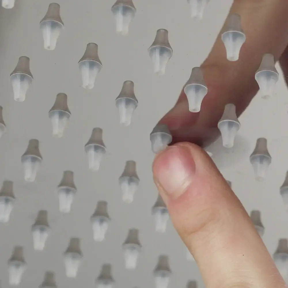Translucent plastic nozzles arranged in a grid on the back side of a decorbites led shower head with temperature control