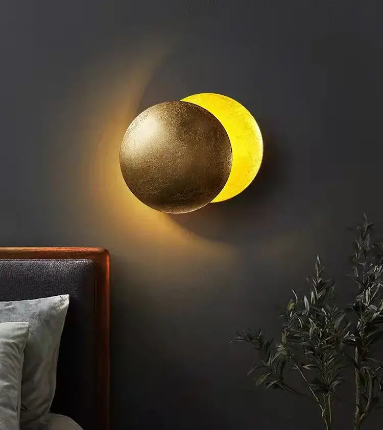 Golden and yellow spherical wall lamp with textured metallic finish from decorbites led solar eclipse collection for modern lighting