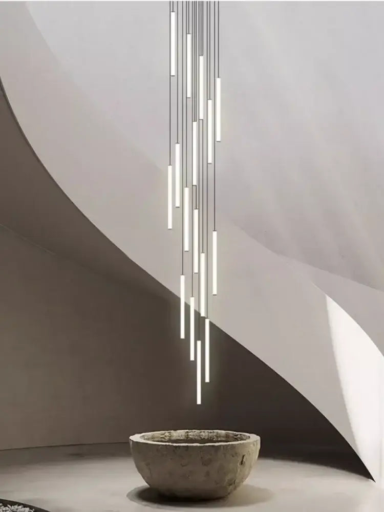 A modern minimalist decorbites™ led spiral staircase chandelier with slender cylindrical tubes for home decor