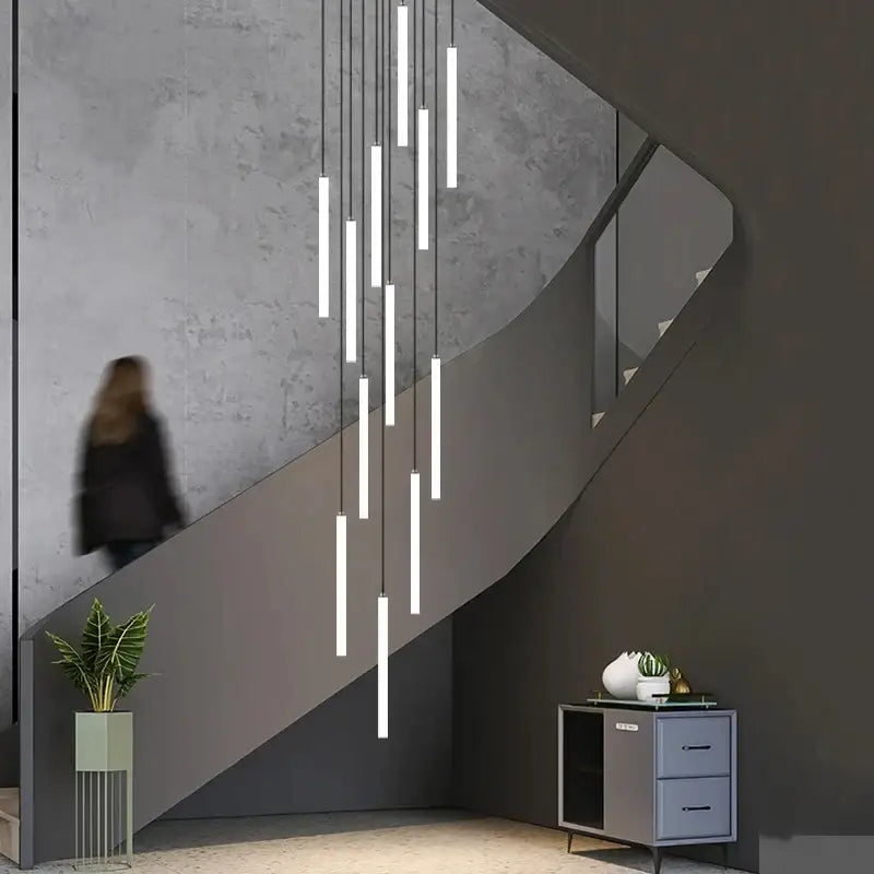 Modern minimalist decorbites™ led spiral staircase chandelier with white cylindrical tubes suspended by thin cords