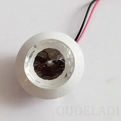 White circular DecorBites LED spot light with faceted crystal lens and visible internal LEDs for home and jewelry cabinet