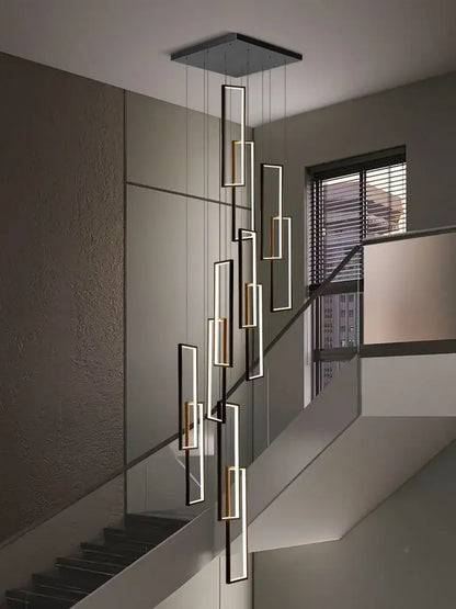 Modern geometric decorbites led stair chandelier with black and gold rectangular fixtures suspended from a square mount