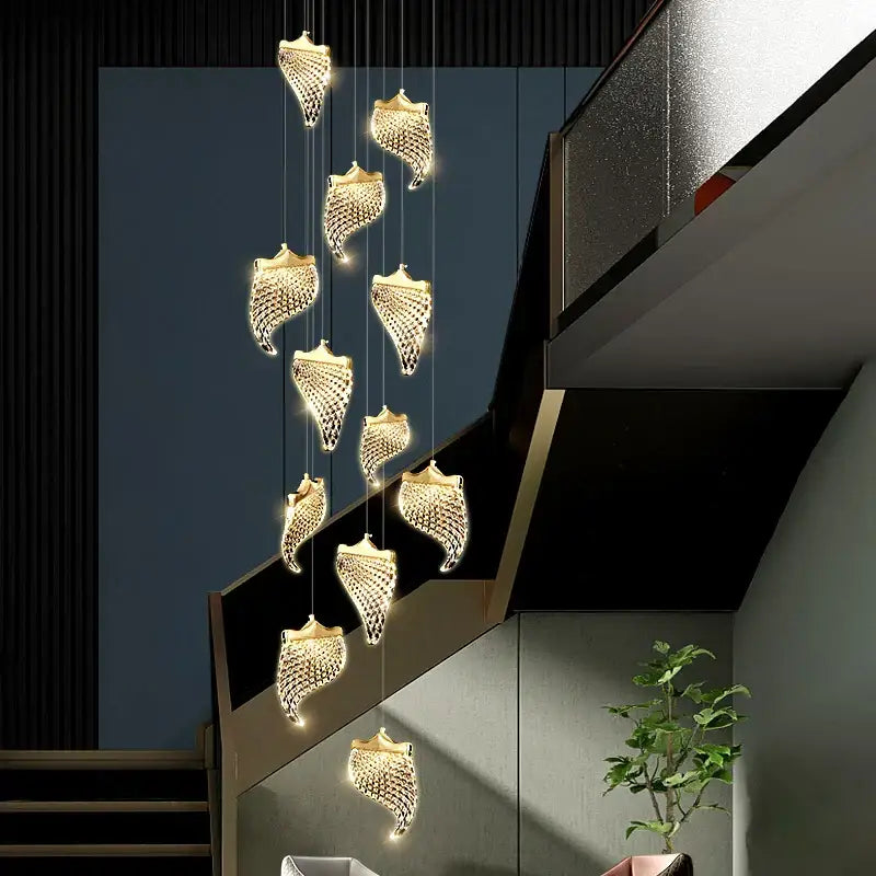 Golden shell-shaped decorbites led staircase chandelier with intricate mesh detailing and warm led lighting for living room