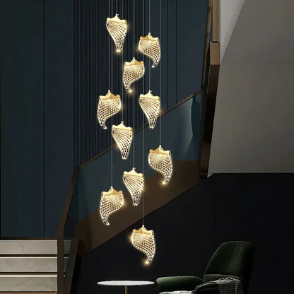 Golden shell-shaped decorbites led staircase chandelier with intricate mesh detailing and warm glowing lights for modern loft lighting