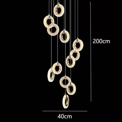 A modern 200cm tall decorbites led staircase pendant chandelier with gold rings and embedded green gemstones