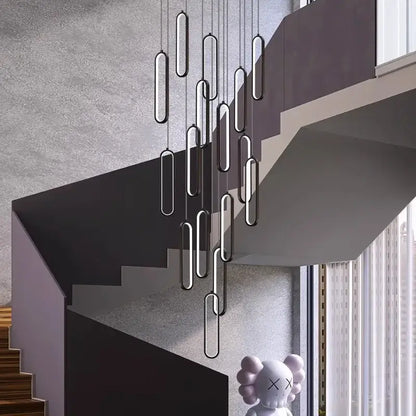 Modern black and silver oval decorbites led staircase pendant lights hanging above a staircase for living room use