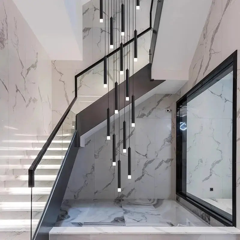 Modern black cylindrical decorbites led staircase chandeliers hang above marble staircase for living room decor