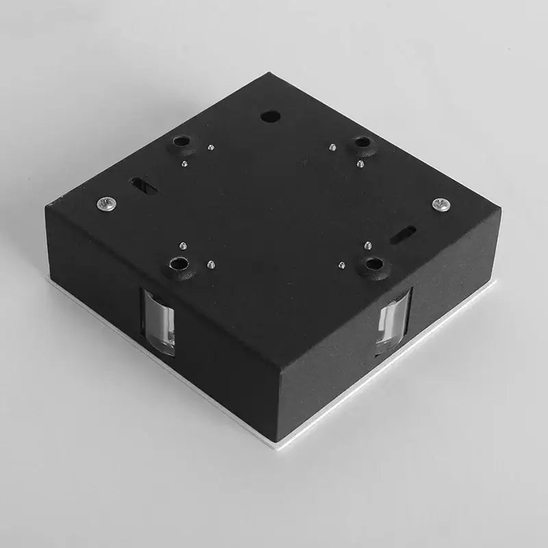 Black square DecorBites led star wall light fixture with metallic screws and transparent lens inserts for indoor decor
