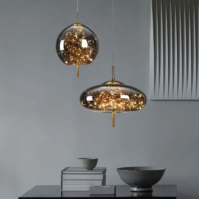 Two modern glass pendant lights with golden filaments suspended by brass rods from decorbites led starry sky lamps