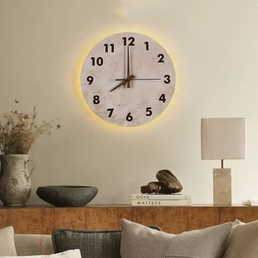 Decorbites™ led stone clock wall lamp sconce with off-white face, black numerals, brown hands, and yellow illuminated glow