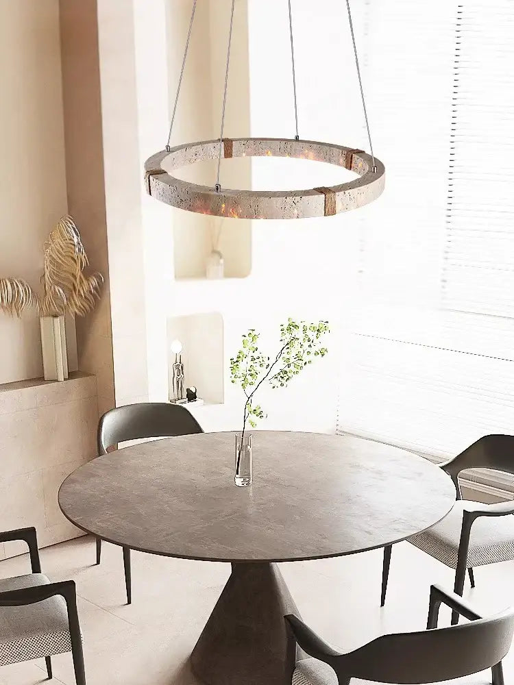 Circular pendant light featuring a textured metallic stone ring with warm lighting by DecorBites led stone ring chandelier