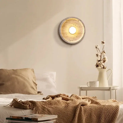 Circular decorbites led stone wall lamp with textured concrete finish and warm glowing center for modern home decor