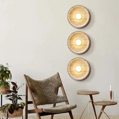 Three circular wall lamps with textured earthy-toned concrete finish and warm glow decorbites led stone wall lamp