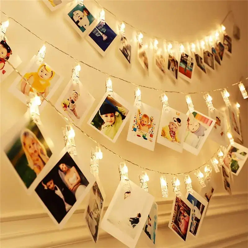 DecorBites led string lights with warm white LEDs and clear plastic clips holding polaroid photos for decoration