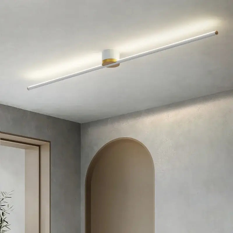 Modern minimalist decorbites led strip ceiling light with white cylindrical body and gold accents for soft ambient indoor lighting