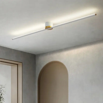 Modern minimalist decorbites led strip ceiling light with white cylindrical body and gold accents for soft ambient indoor lighting