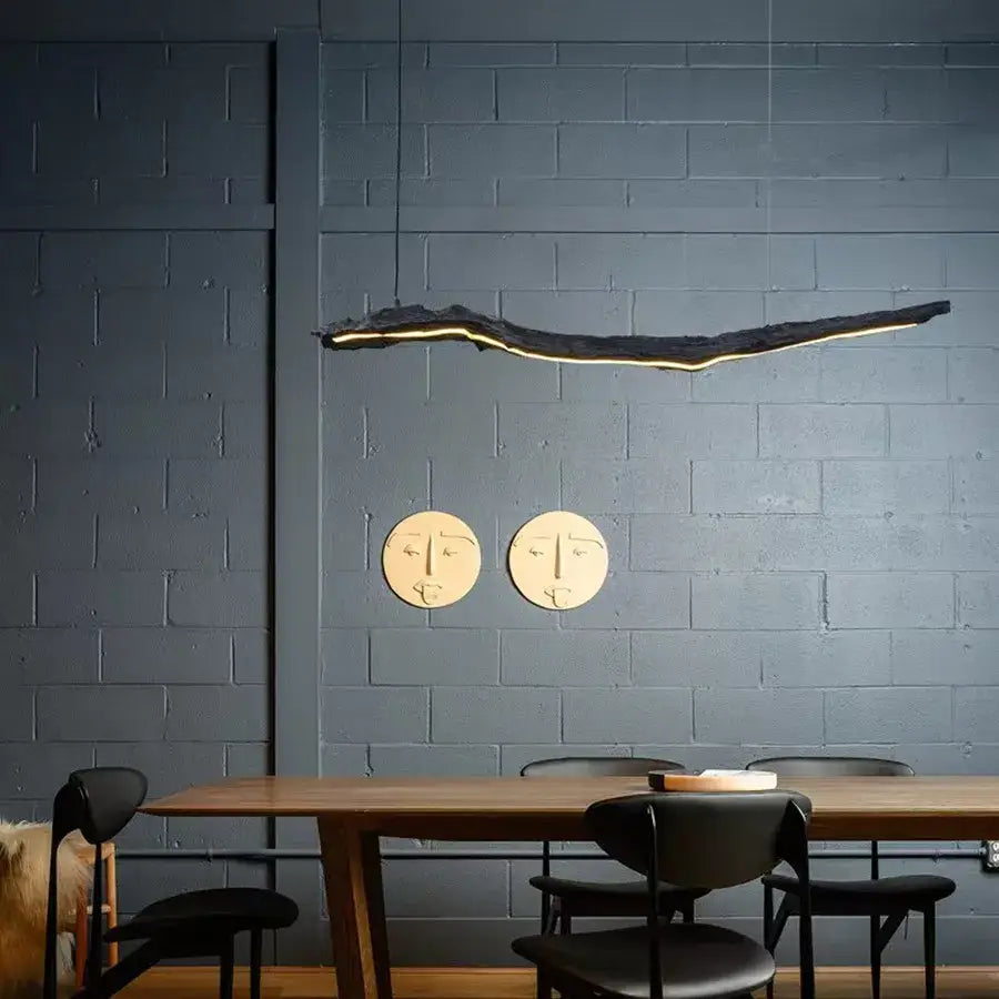 A sleek black organic pendant light with glowing gold edge in dining room featuring decorbites led strip lights