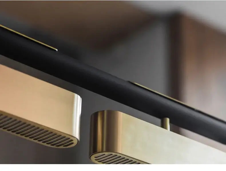 Modern minimalist strip led ceiling-mounted speakers with brushed brass finishes and black accents for dining areas