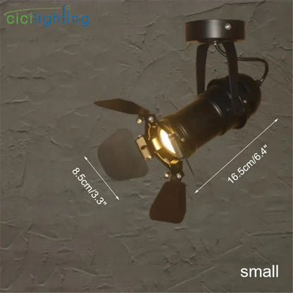 Black decorbites led surface mount spotlight with brass accents and adjustable wings for living room and retail lighting